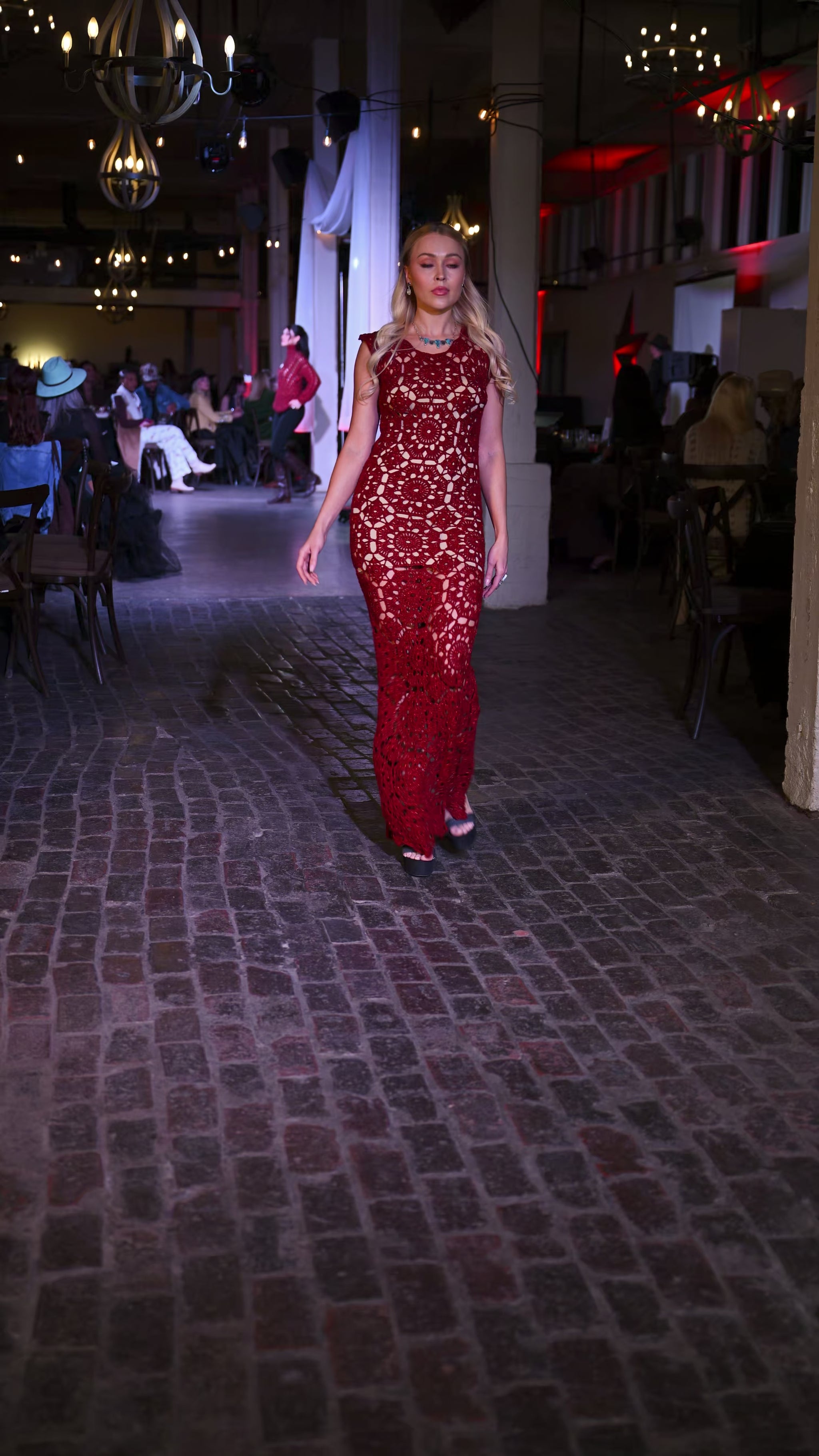woman wearing red dress and ithaca peak turquoise and grey moonstone necklace with matching two stone turquoise ring and grey moonstone earrings walking on runway