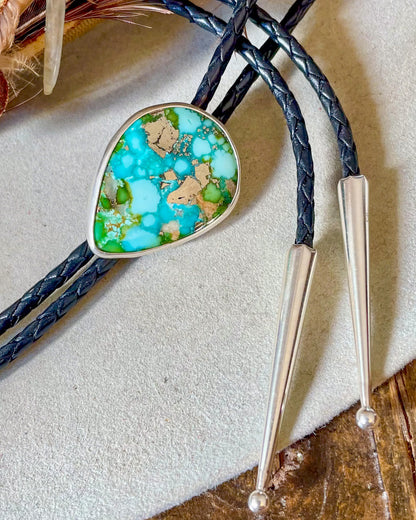 Bolo tie with turquoise and pyrite stone with black bolo cord and silver tips