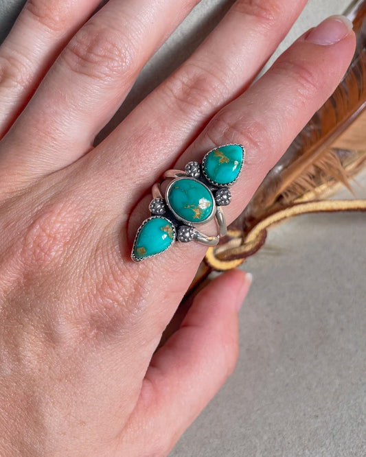 three stone emerald valley turquoise ring with floral accents on split shank band